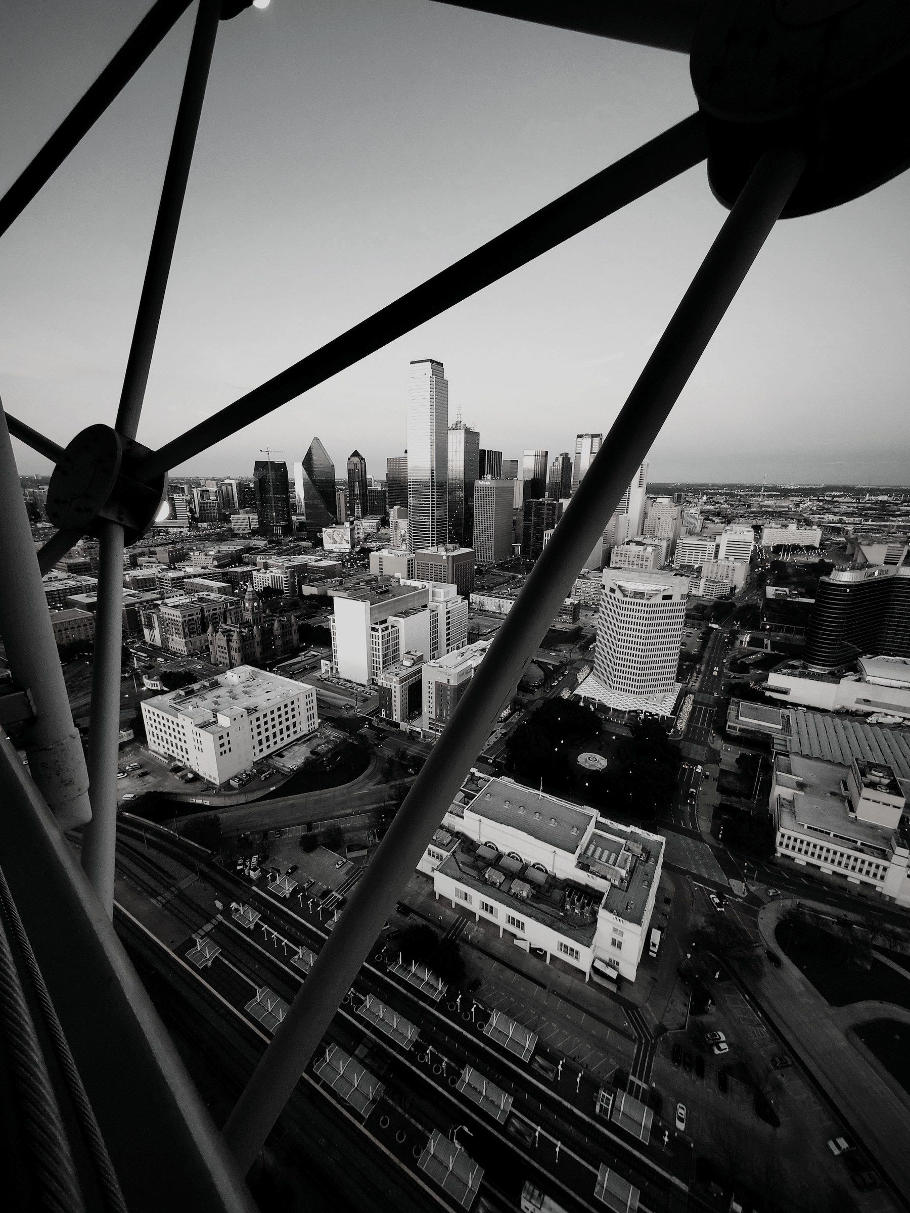 A city skyline framed through the steel structure of an observation tower